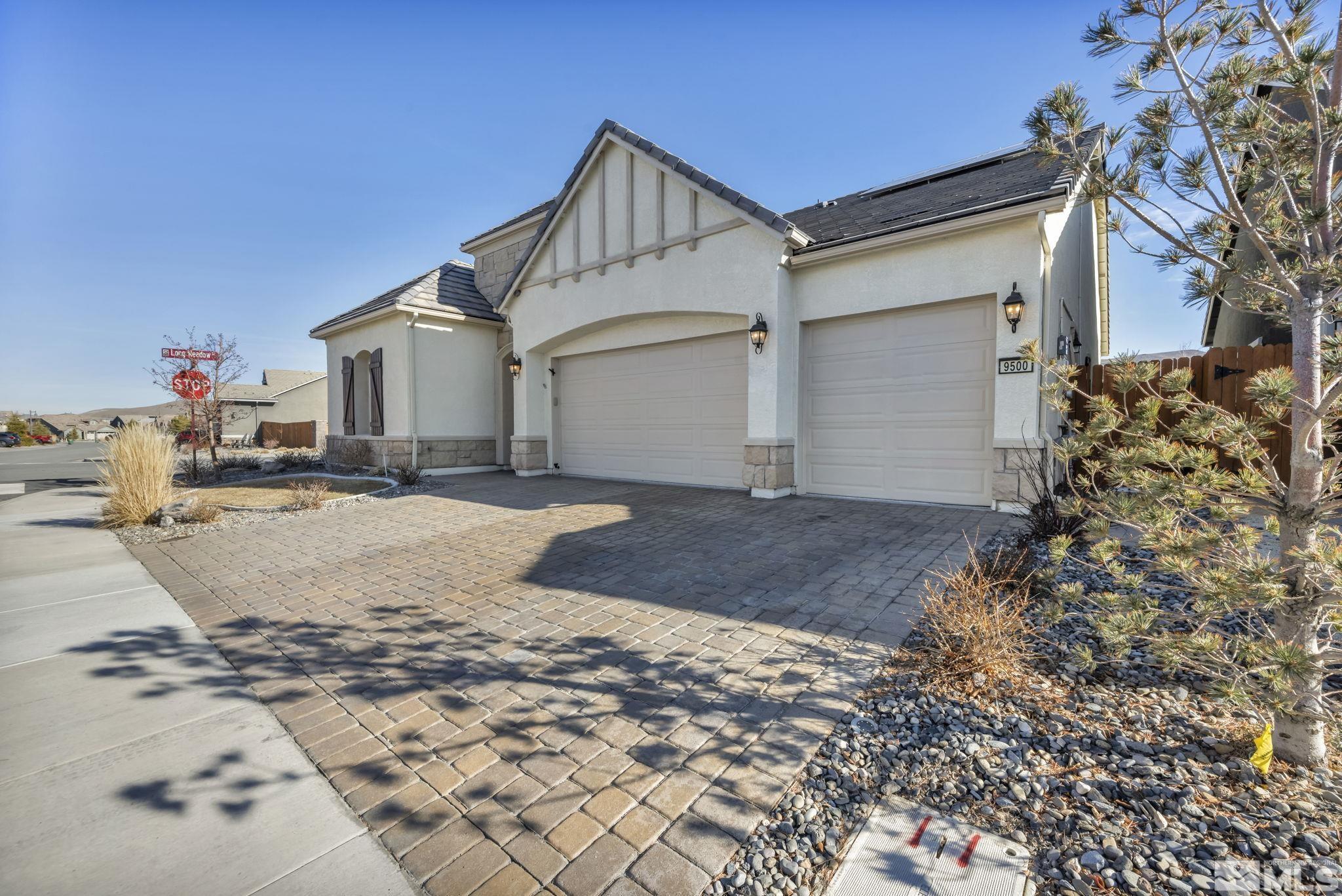 9500 Hawkshead Road Reno, NV 89521 - Photo 2 of 40 a view of a white house with a yard