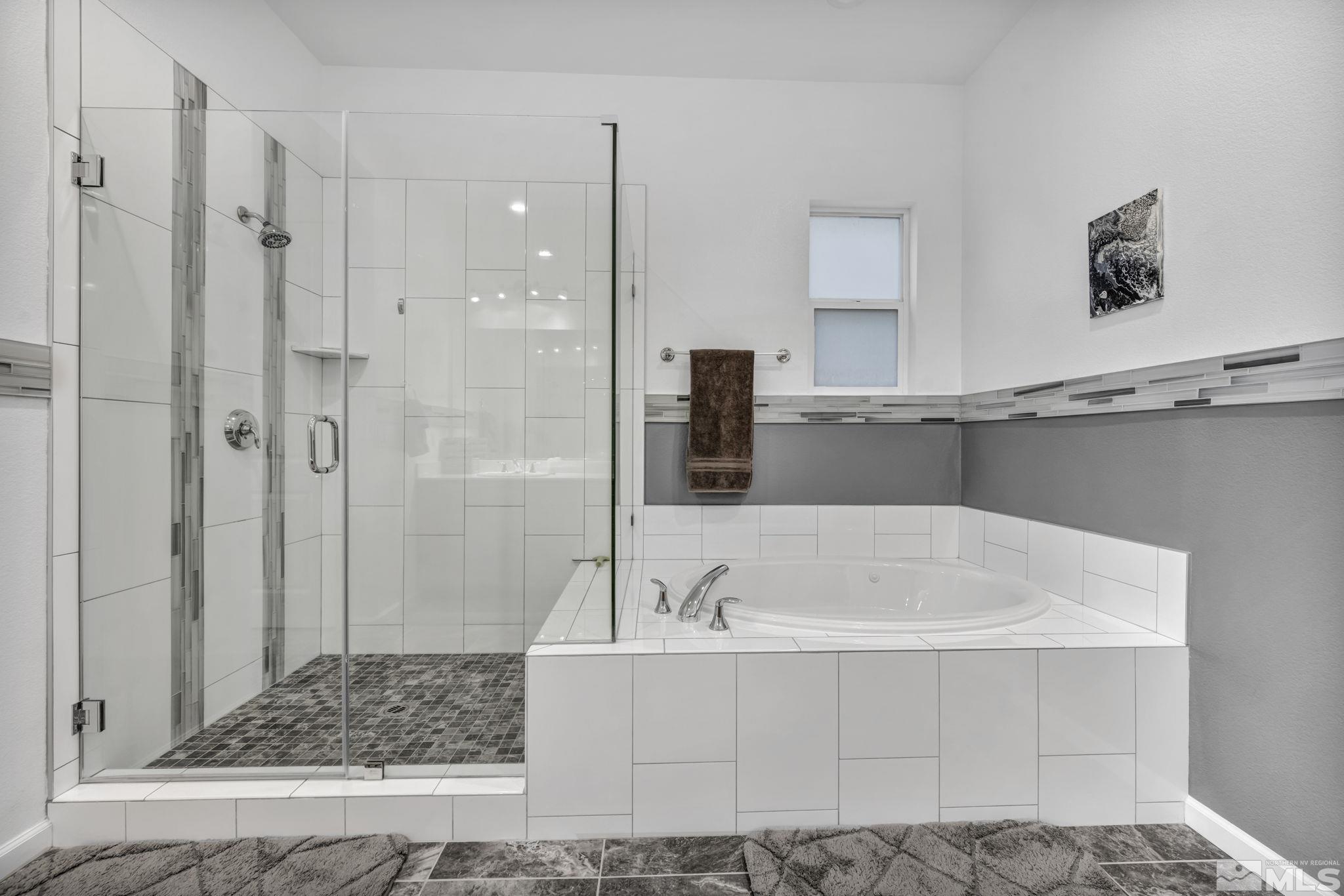 9500 Hawkshead Road Reno, NV 89521 - Photo 25 of 40 a bathroom with a tub a sink and a shower