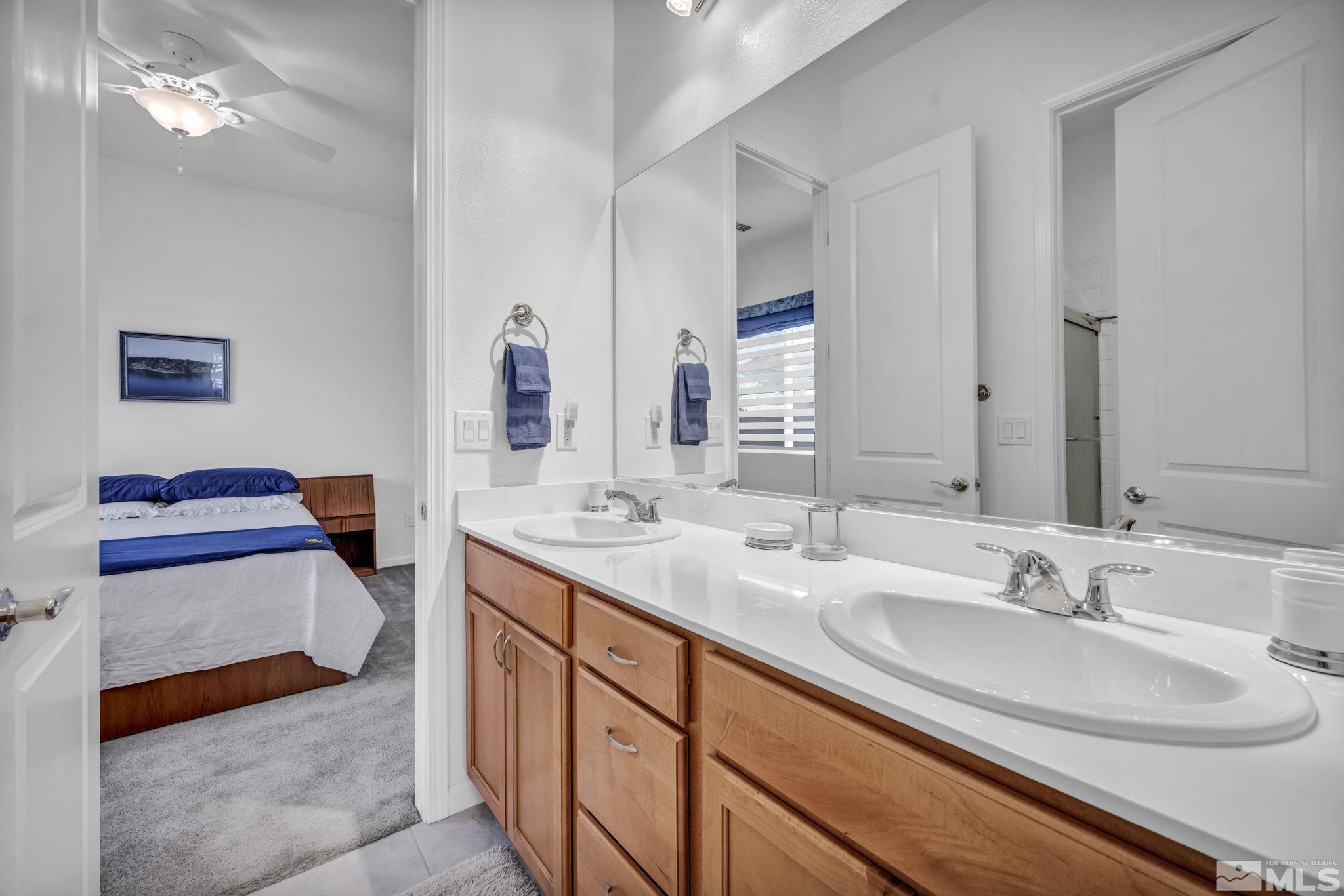 9500 Hawkshead Road Reno, NV 89521 - Photo 28 of 40 a en suite bathroom with double vanity and a mirror