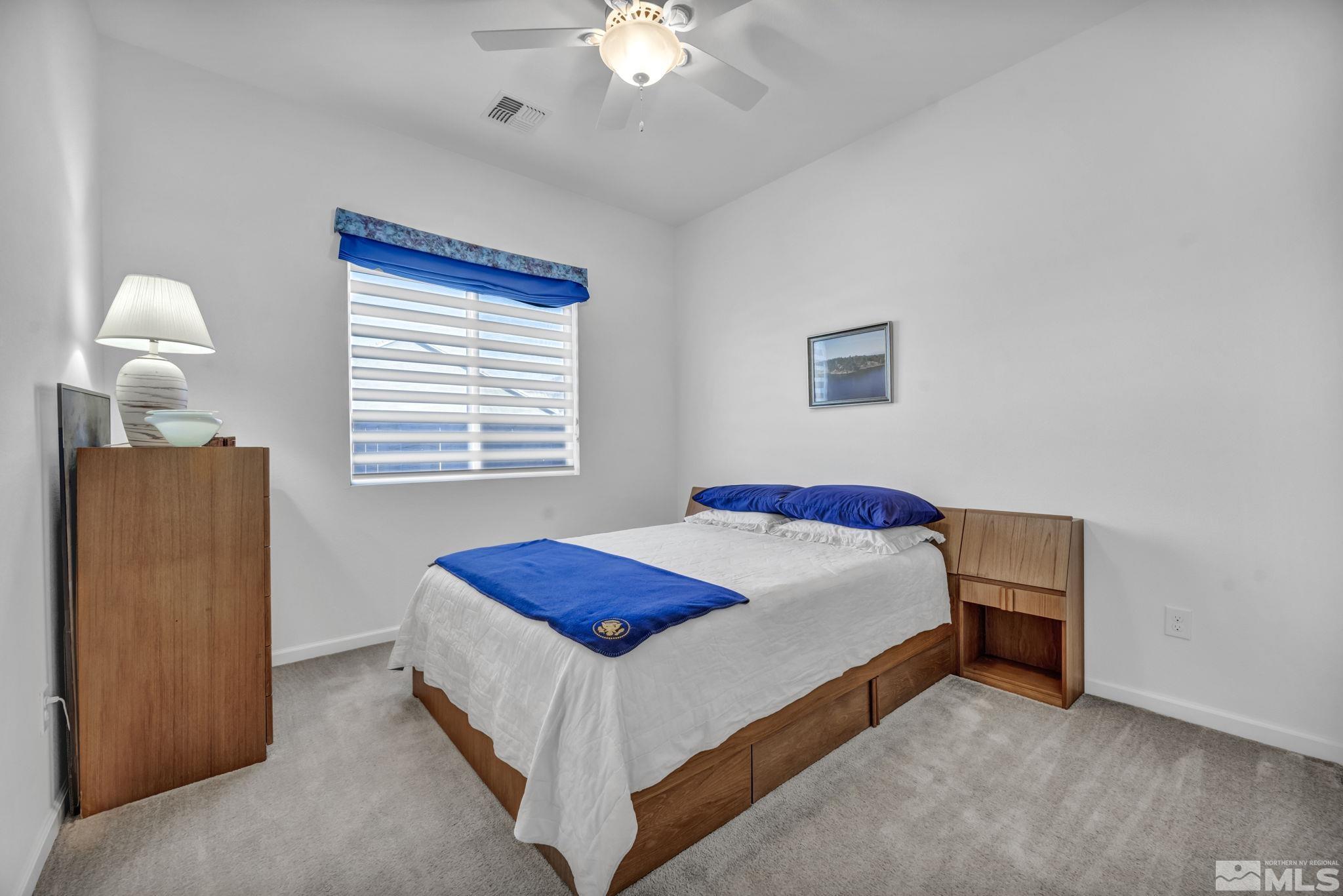9500 Hawkshead Road Reno, NV 89521 - Photo 29 of 40 a bedroom with a bed and a chandelier