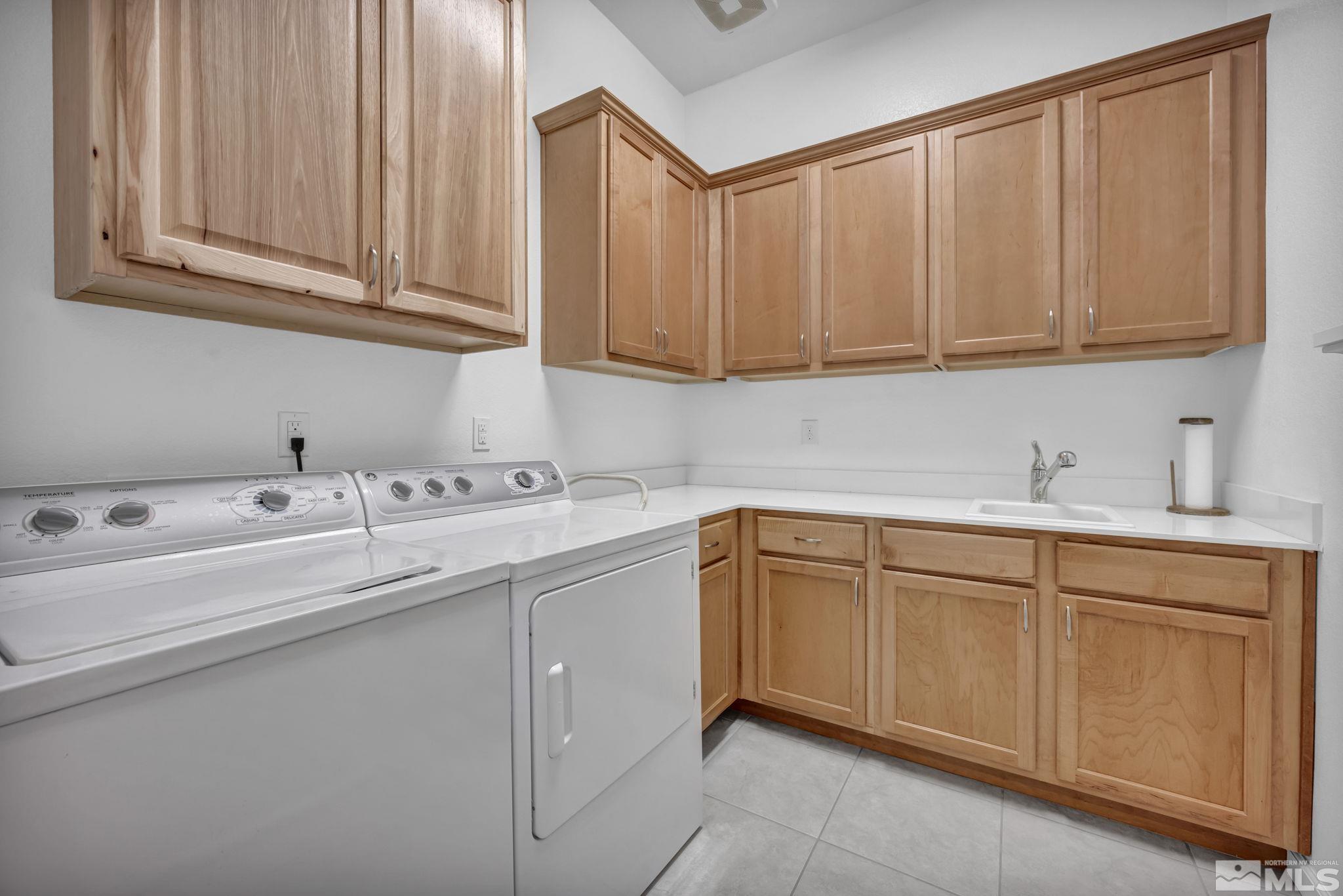 9500 Hawkshead Road Reno, NV 89521 - Photo 30 of 40 a kitchen with sink cabinets and utility
