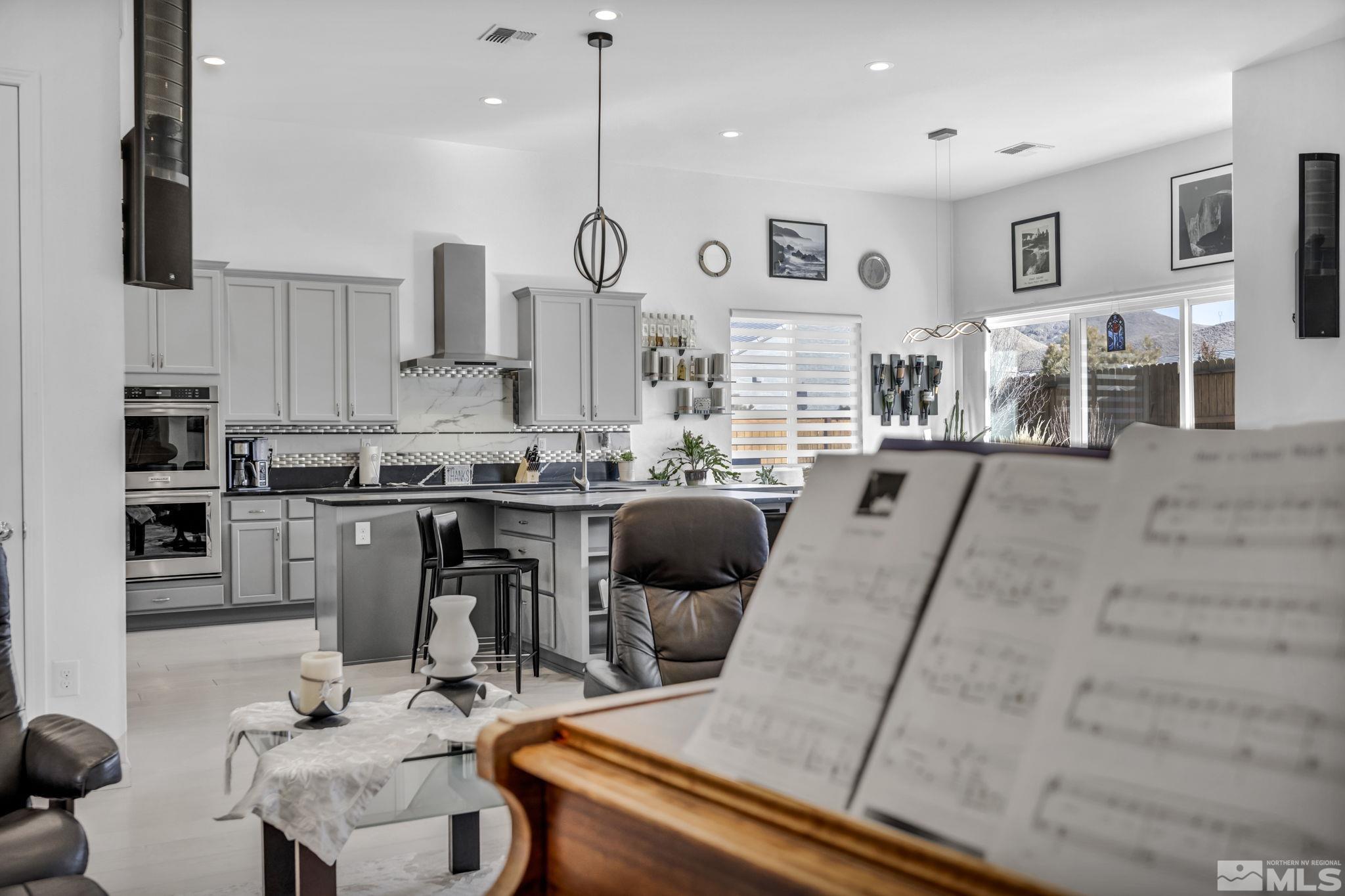 9500 Hawkshead Road Reno, NV 89521 - Photo 7 of 40 a kitchen with stainless steel appliances kitchen island granite countertop a sink and cabinets
