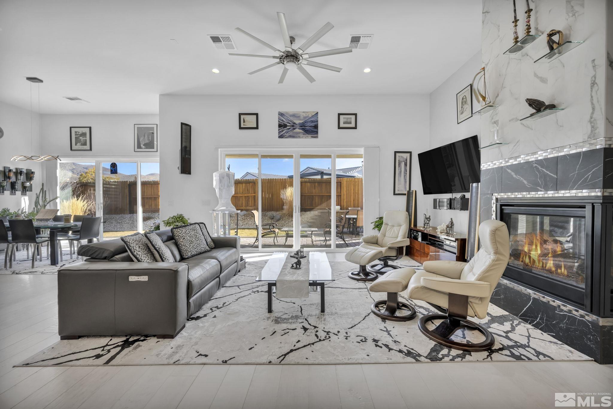 9500 Hawkshead Road Reno, NV 89521 - Photo 8 of 40 a living room with fireplace furniture and a flat screen tv