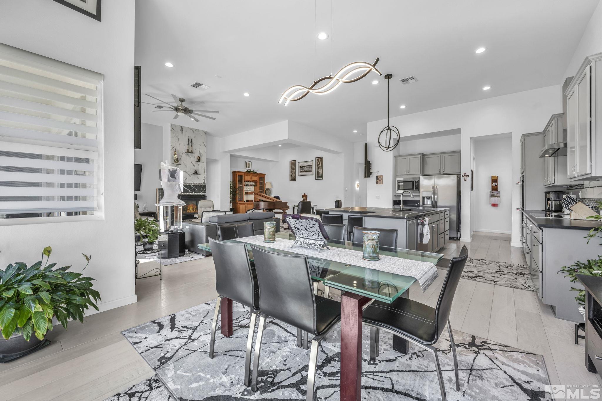 9500 Hawkshead Road Reno, NV 89521 - Photo 9 of 40 a view of a dining room and livingroom with furniture wooden floor a chandelier