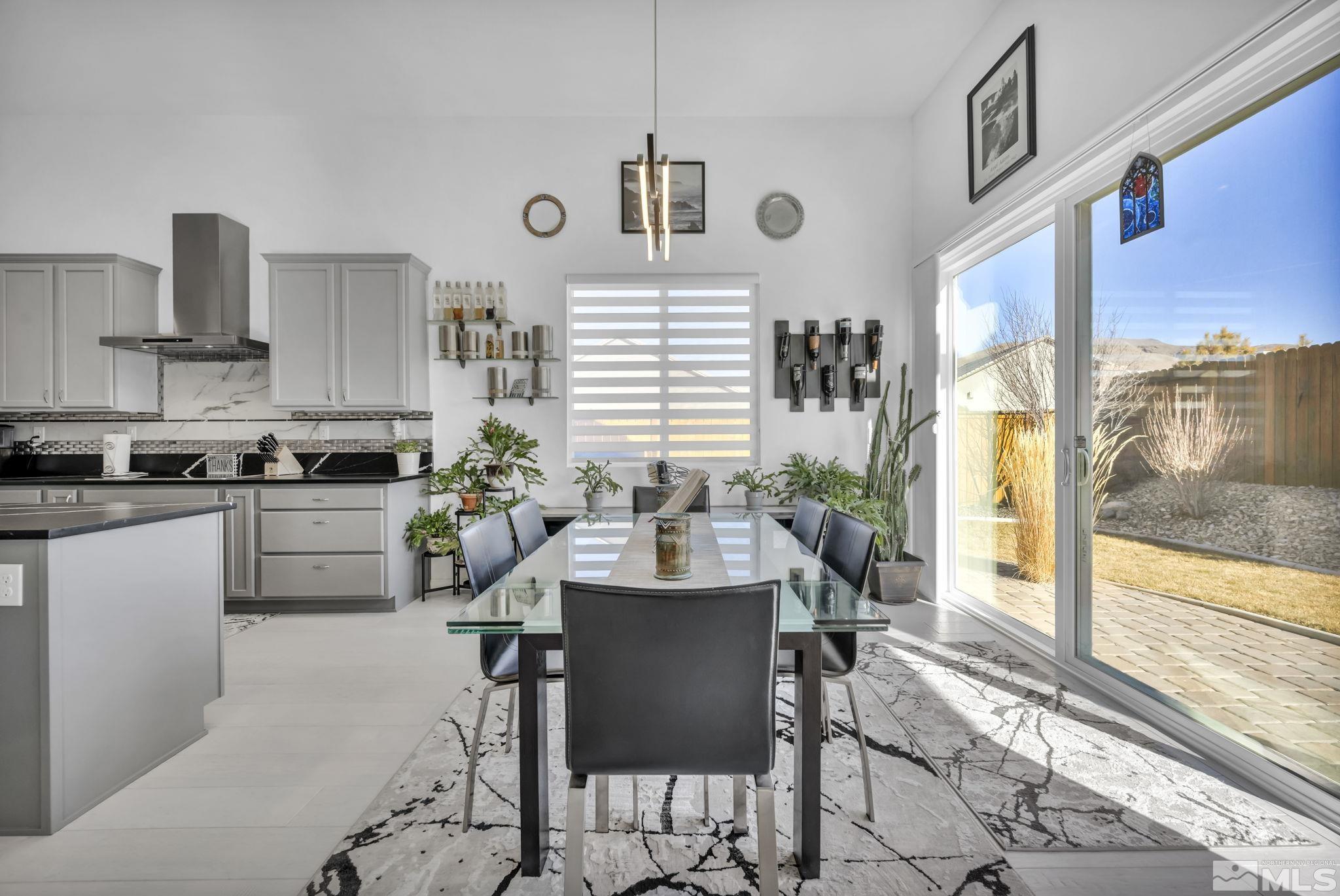 9500 Hawkshead Road Reno, NV 89521 - Photo 10 of 40 a kitchen with a table chairs refrigerator and cabinets