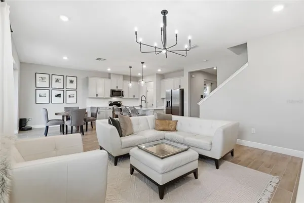 a living room with furniture and a chandelier