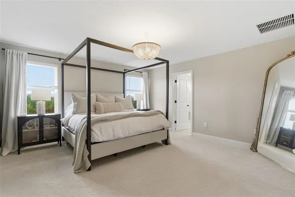 a bedroom with a bed and chandelier