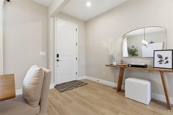 a view of entryway and hall with wooden floor