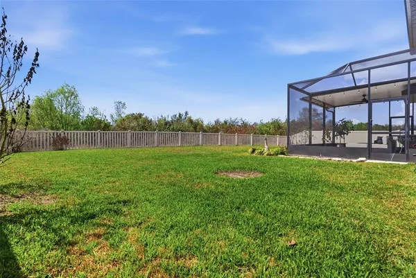 a view of house with backyard