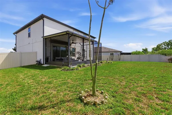 an aerial view of a house with a yard and lake view