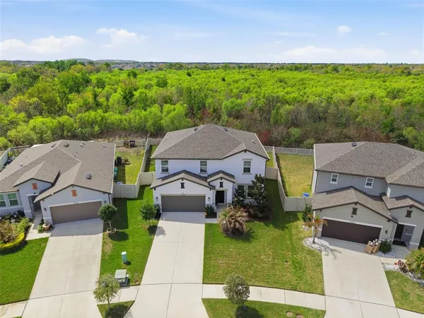 an aerial view of a house with garden space and street view