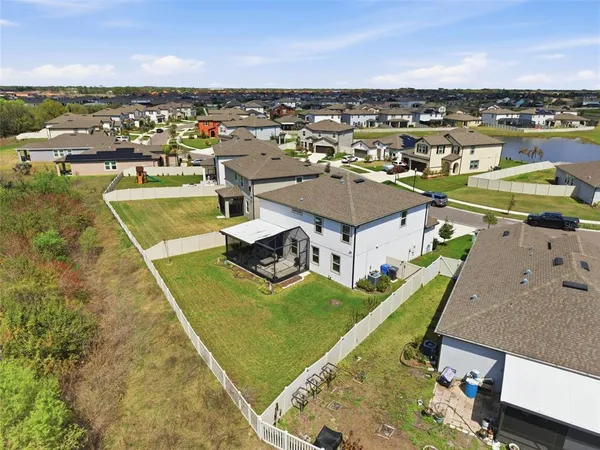 an aerial view of residential houses with outdoor space