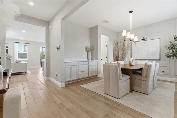 a view of a dining room with furniture window and wooden floor