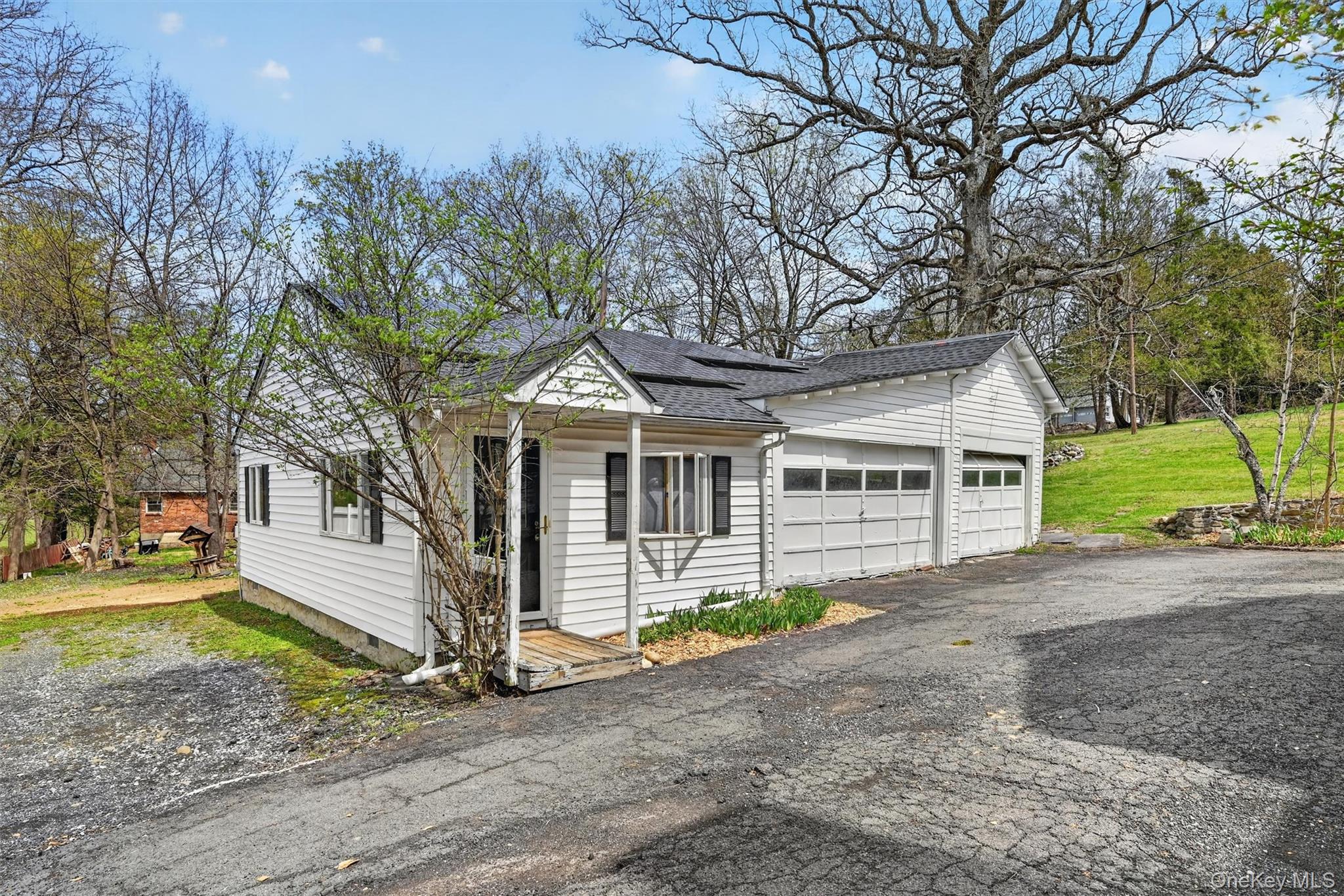 12 Perry Creek Road Washingtonville, NY 10992 - Photo 31 of 48 a front view of a house with a garden and trees