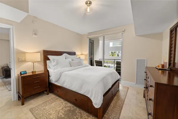 a bedroom with a bed and a large mirror