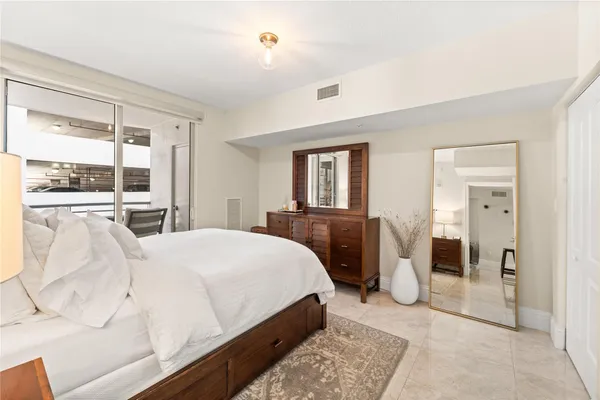 a bedroom with a bed and a dresser