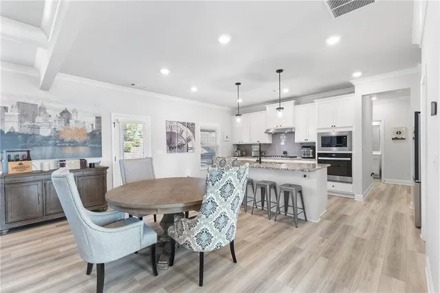 a view of a dining room with furniture and wooden floor