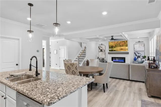 a living room with furniture and kitchen view