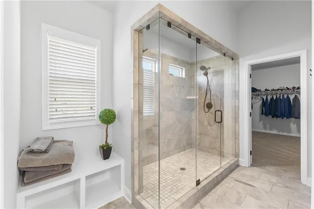 a bathroom with a shower and a sink mirror