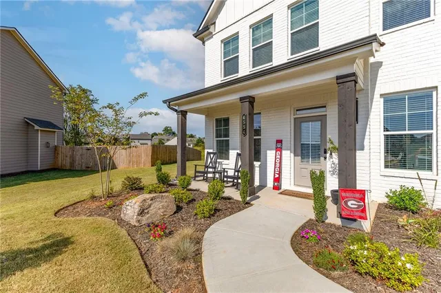 a front view of a house with outdoor seating
