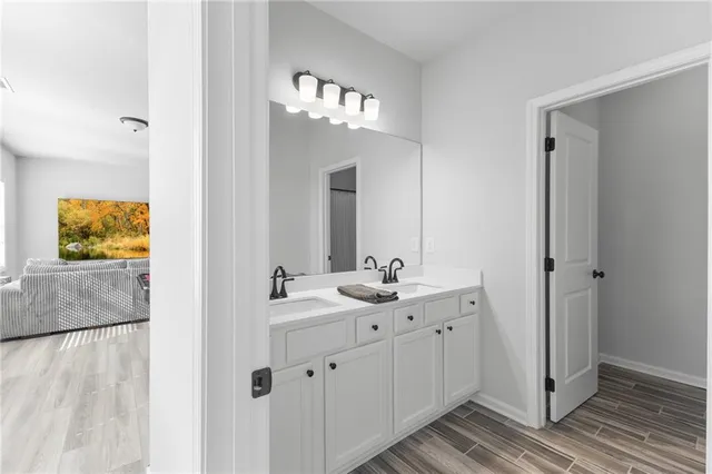 a bathroom with a double vanity sink and mirror