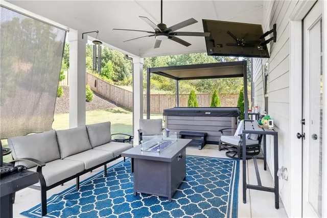 a living room with furniture a fireplace and a large window