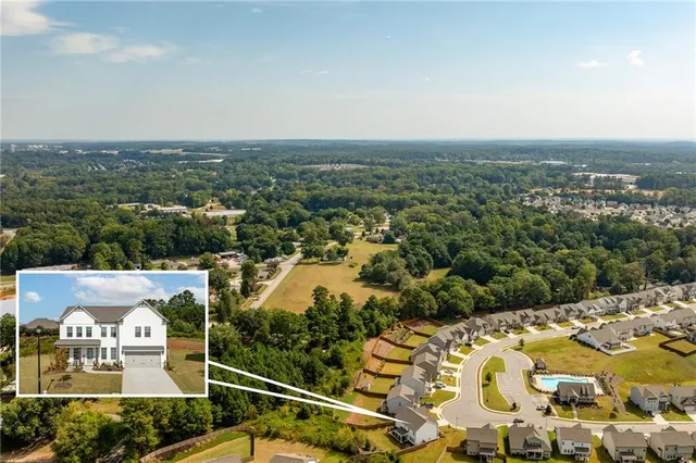 an aerial view of residential houses with outdoor space
