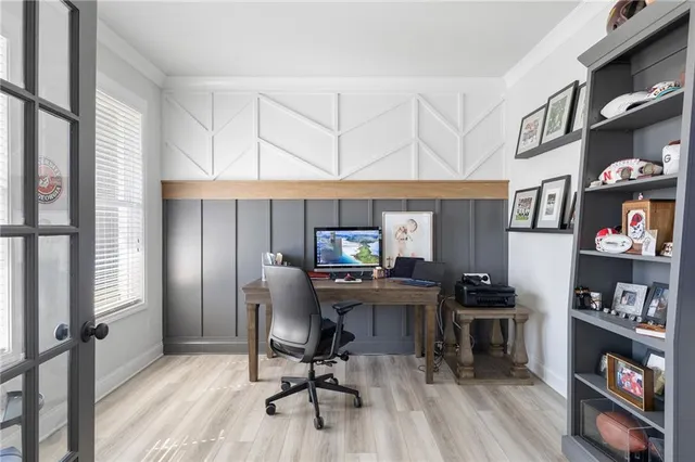 a view of a workspace with furniture and a window