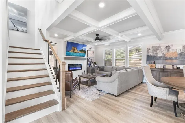 a living room with fireplace furniture and a wooden floor