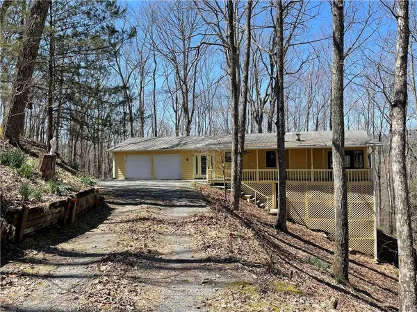 a view of a house with a yard covered with snow in the background