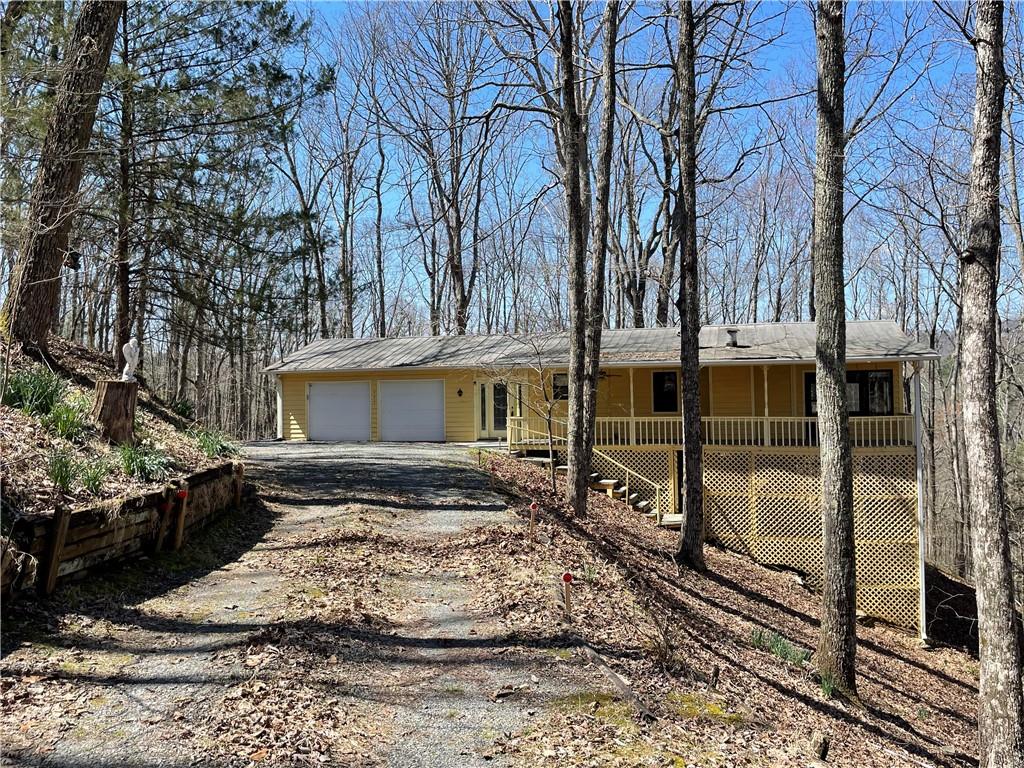 596 Ripshin Mountain Road Blue Ridge, GA 30513 - Photo 1 of 19 a view of a house with a yard covered with snow in the background
