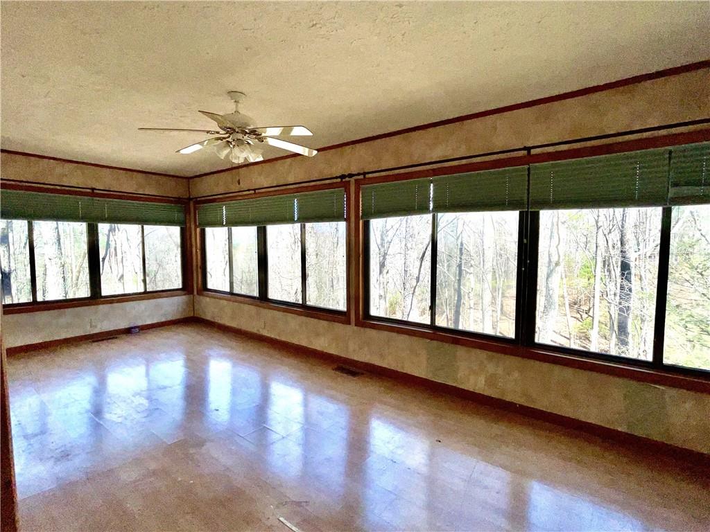 596 Ripshin Mountain Road Blue Ridge, GA 30513 - Photo 6 of 19 a view of an empty room with wooden floor and a window