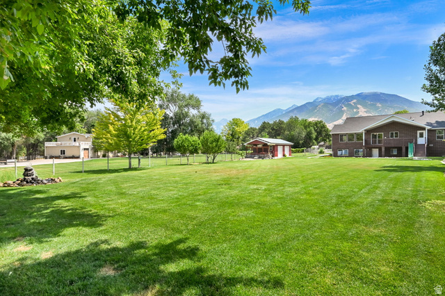 13658 South Fort Street Draper, UT 84020 - Photo 69 of 87 Expansive lawn area featuring mature trees and a decorative rock water feature