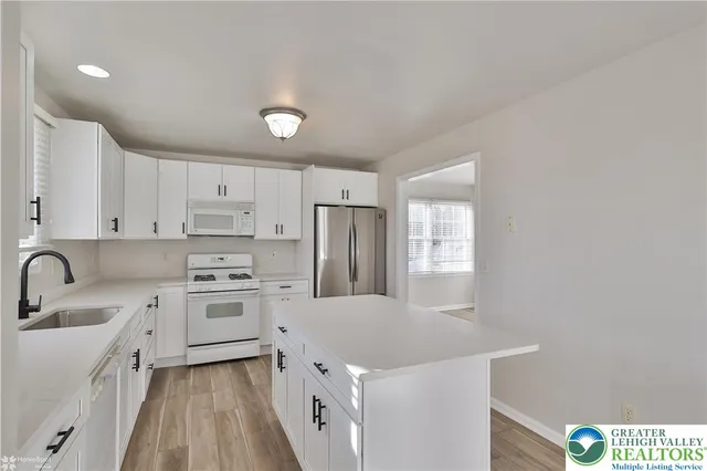 a bathroom with a sink a bathtub and a window