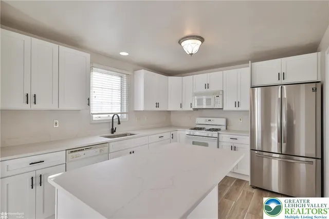 a bathroom with a tub sink and a shower
