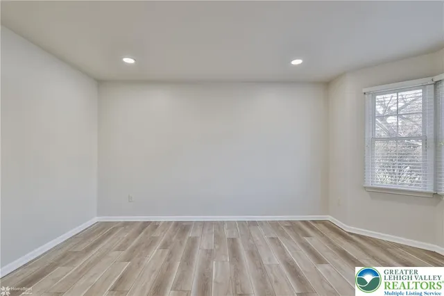 a kitchen with cabinets stainless steel appliances and a window