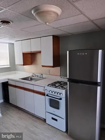 a kitchen with a stove a refrigerator and a sink