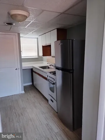 a kitchen with stainless steel appliances a refrigerator and a stove