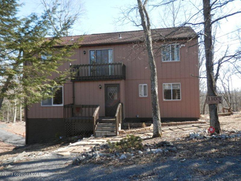 a view of a house with wooden fence
