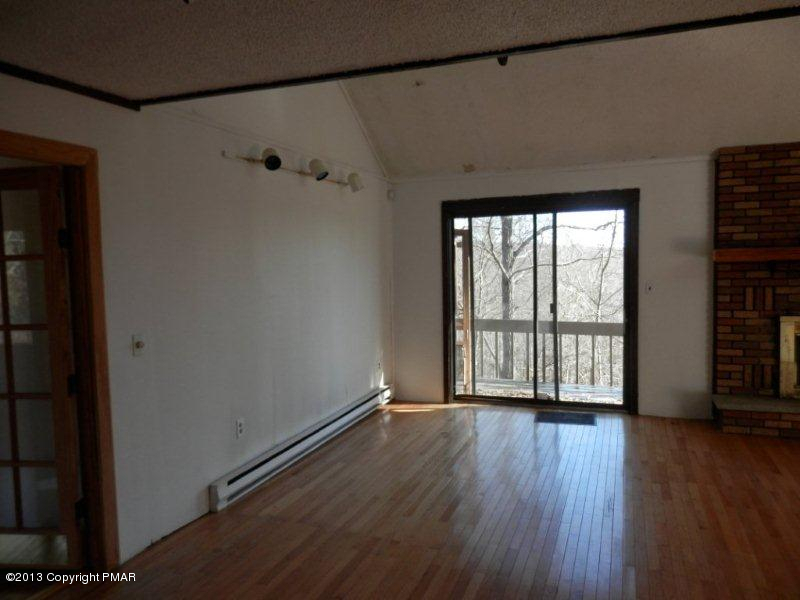 1103 Elgin Way Bushkill, PA 18324 - Photo 4 of 11 a view of an empty room with a window and wooden floor