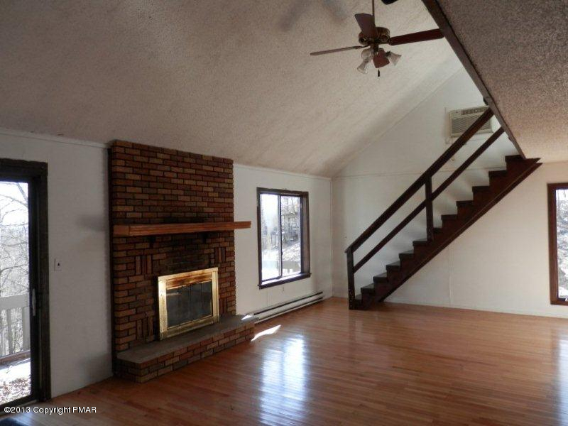 1103 Elgin Way Bushkill, PA 18324 - Photo 5 of 11 a view of an empty room with wooden floor fireplace and a window