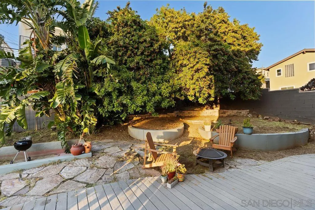 1570 Linwood Street San Diego, CA 92103 - Photo 15 of 36 a view of a backyard with table and chairs and potted plants