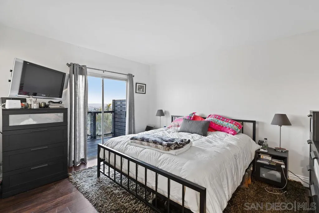 1570 Linwood Street San Diego, CA 92103 - Photo 17 of 36 a bedroom with a bed and a flat screen tv