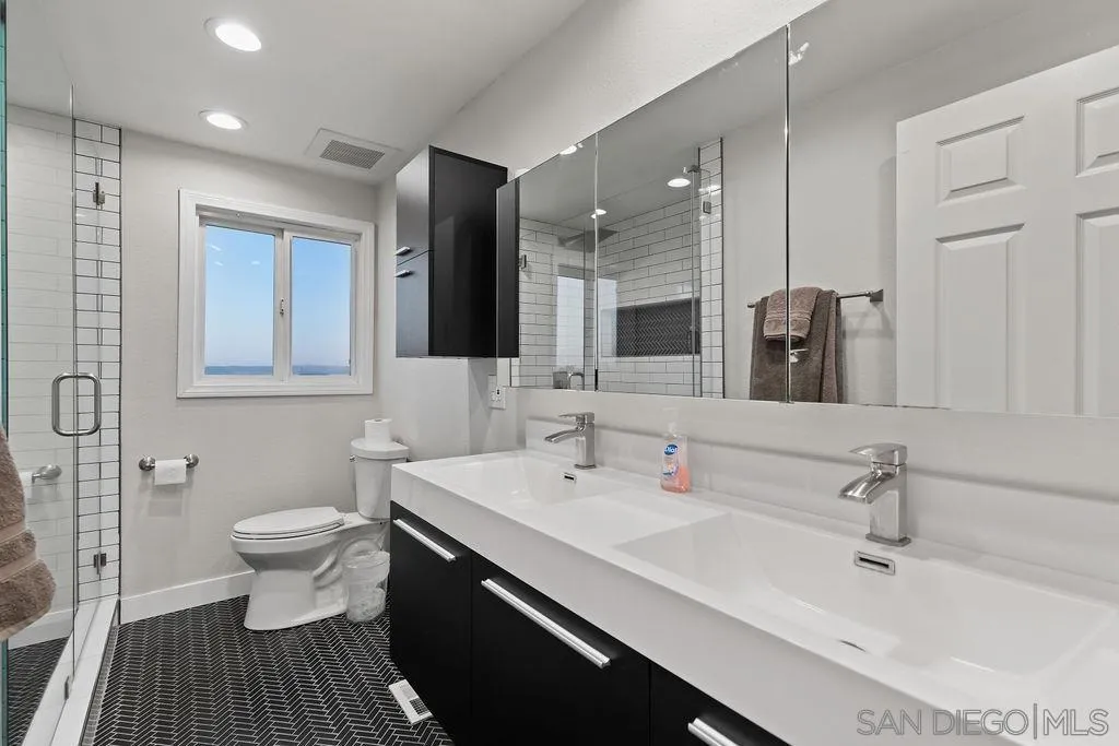 1570 Linwood Street San Diego, CA 92103 - Photo 18 of 36 a bathroom with a sink and a mirror