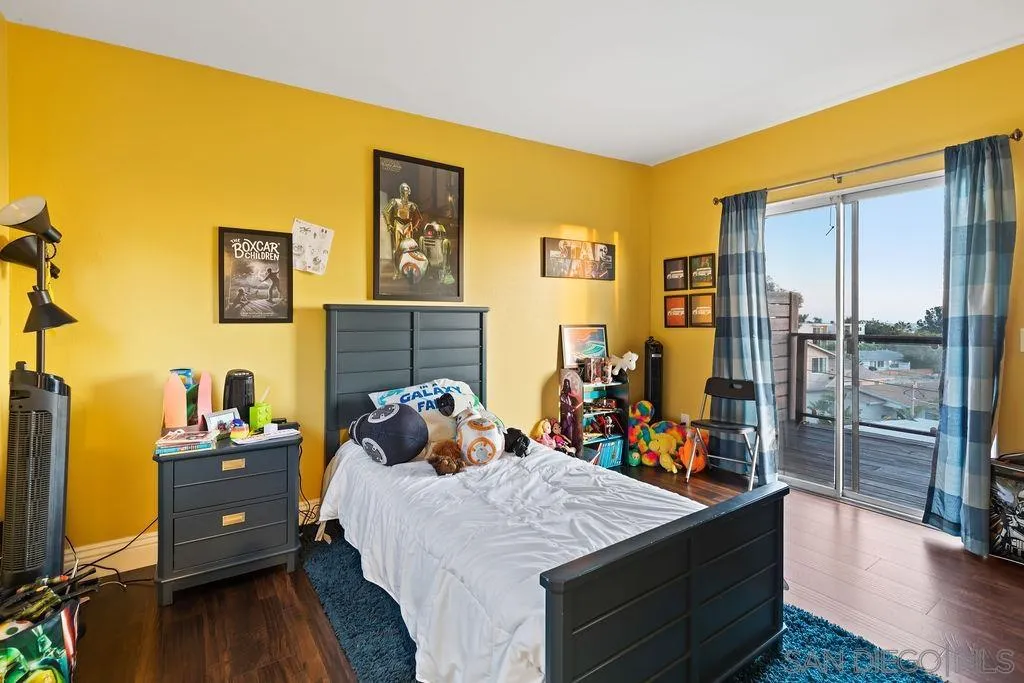1570 Linwood Street San Diego, CA 92103 - Photo 21 of 36 a bed room with a bed mirror and a flat tv screen on a dresser