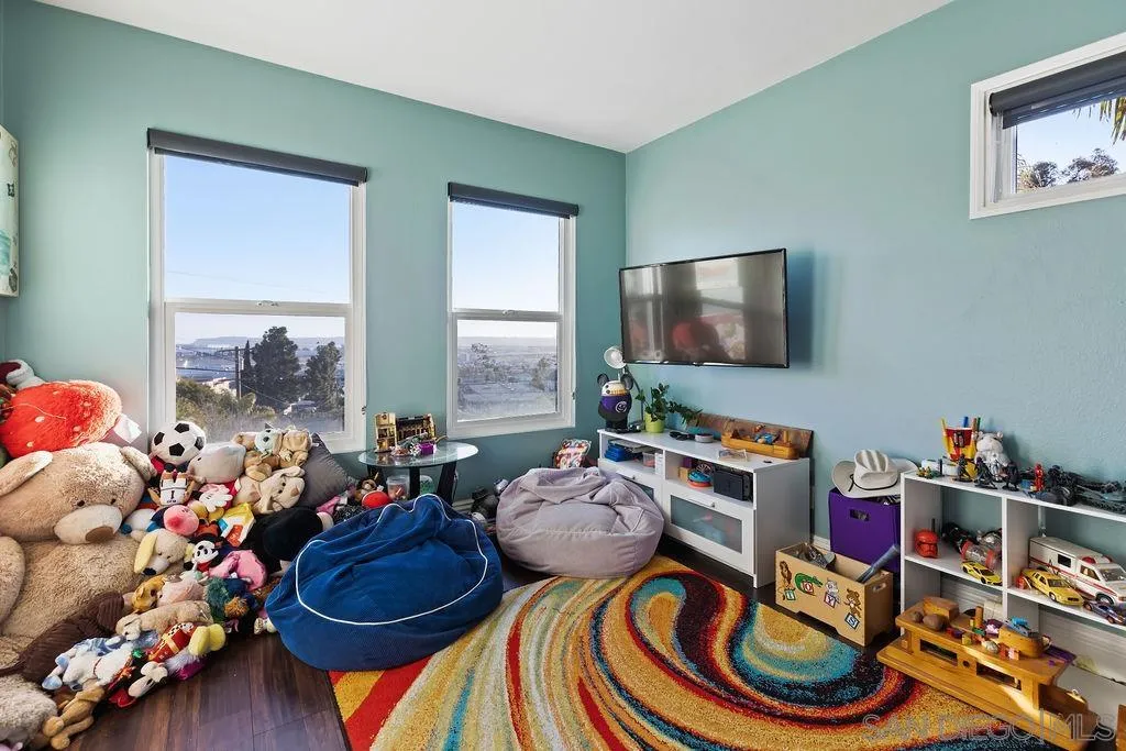1570 Linwood Street San Diego, CA 92103 - Photo 22 of 36 a room with lots of white furniture and a wooden floor