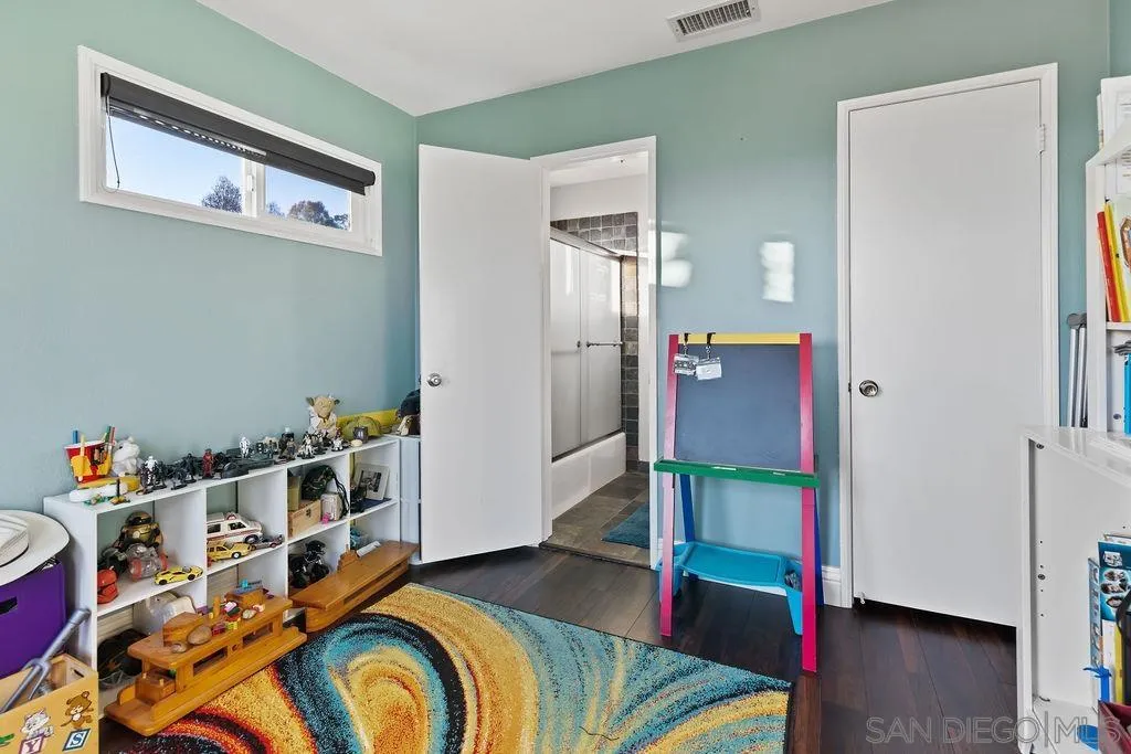 1570 Linwood Street San Diego, CA 92103 - Photo 23 of 36 a bed room with a bed and a desk