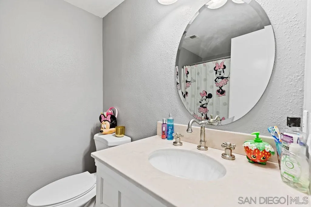1570 Linwood Street San Diego, CA 92103 - Photo 26 of 36 a bathroom with a sink mirror and toilet
