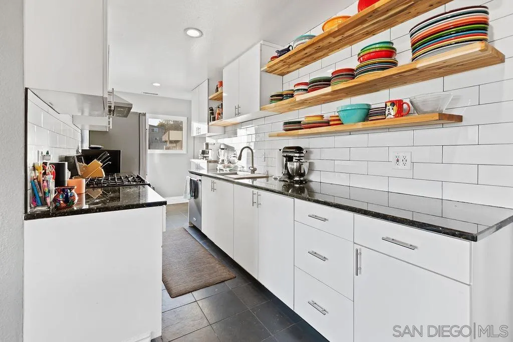 1570 Linwood Street San Diego, CA 92103 - Photo 8 of 36 a kitchen with stainless steel appliances granite countertop a sink and cabinets
