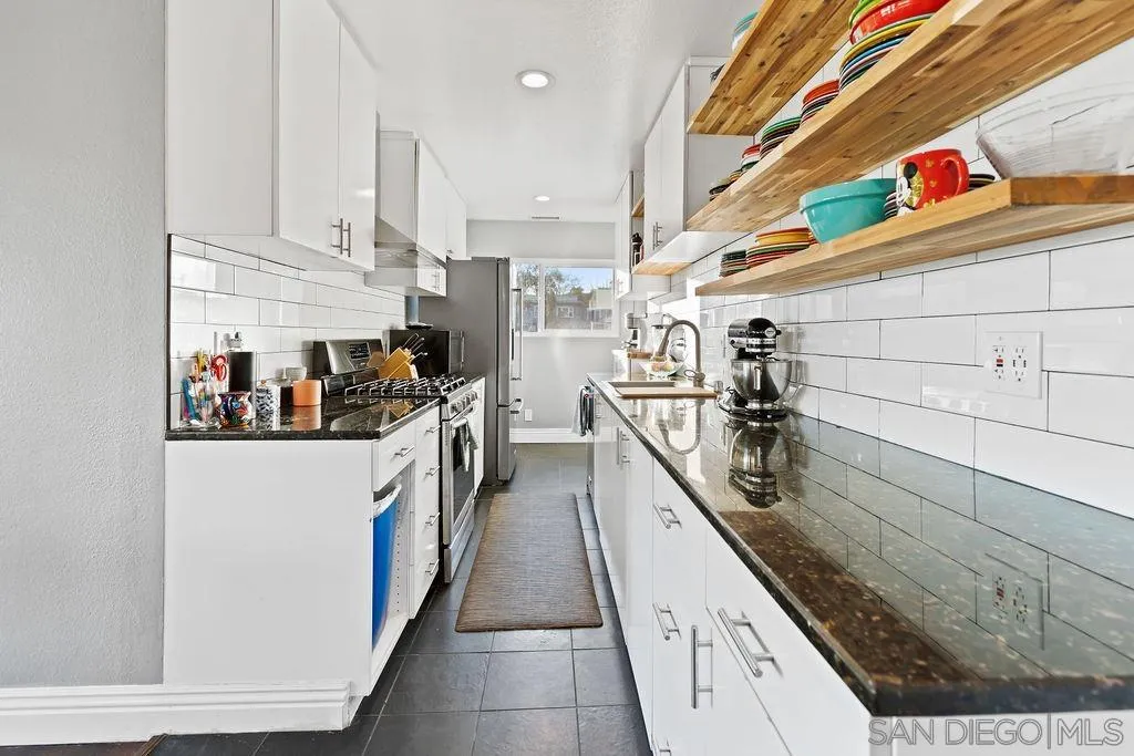 1570 Linwood Street San Diego, CA 92103 - Photo 9 of 36 a kitchen with stainless steel appliances granite countertop lots of counter top space
